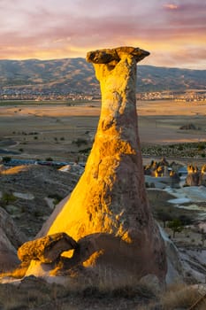 Rocks looking like mushrooms dramatically lit by a sunset in Cappadocia, Turkey