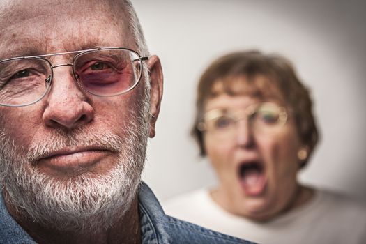 Battered and Scared Man with Screaming Angry Woman Behind.