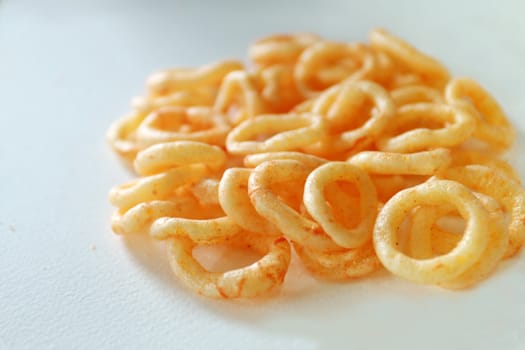 The snack have yellow color and loop shape.