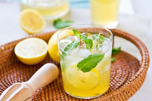 Lemonade with fresh lemon and mint by lemon reamer