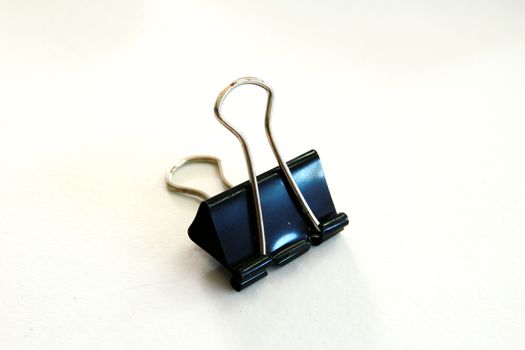 Black paper clip which have traces of work for along time.