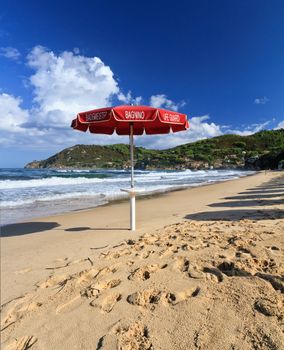 Lifeguard's umbrella on the Biodola beach, Elba Island, Italy