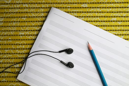 There are tools for  writing song such as earphone pencil and staff sheet.