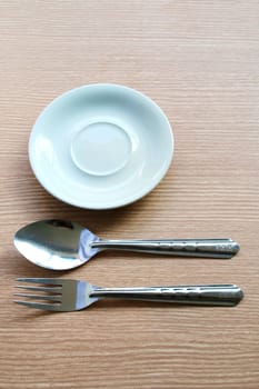 There are table set which have spoon fork and plate.