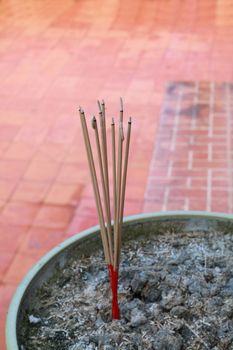 There are joss sticks  burning in the incense burner.