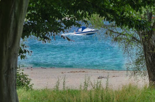 Overlooking a small beach section on the Rhine in the background a boat.