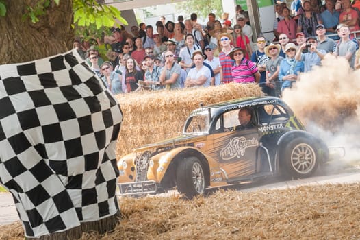 Goodwood, UK - July 13, 2013: Dusty vehicle donuts performed by expert stunt driver Terry Grant at the Festival of Speed event held at Goodwood, UK