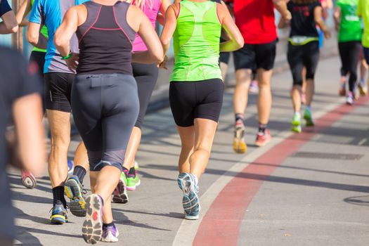 Group of active people running in the city. Healthy lifestyle. Weight Loss. Urban marathon run.