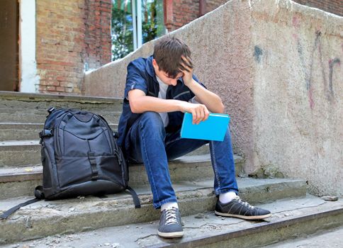 Sad Student with the Book on the landing steps