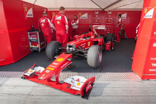 Goodwood, UK - July 13, 2013: Ferrari Formula 1 race car and mechanics at the Festival of Speed event in Goodwood, UK