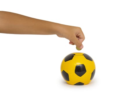 Closeup of woman's hand inserting coin in moneybox