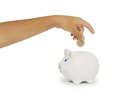 Closeup of woman's hand inserting coin in moneybox