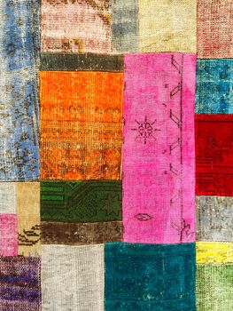 Colorful vintage patchwork rug with ethnic design.