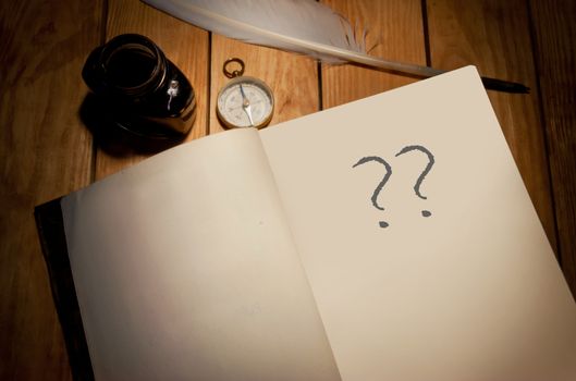 Question marks handwritten in a book 