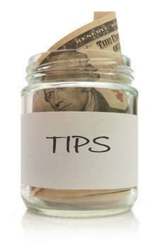 Jar full of dollar note tips over a white background