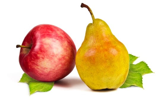 Red apple and yellow ripe pear and green leaves on a white background