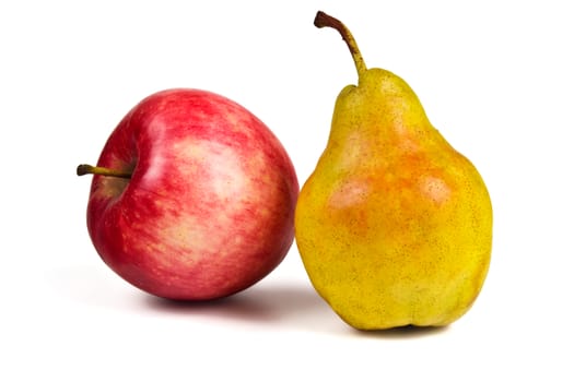 Red apple and yellow ripe pear on a white background
