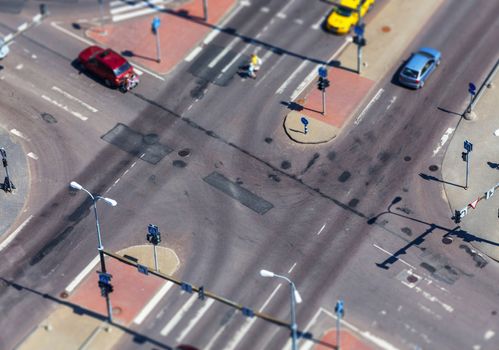 high angle view of a street intersection with cross walk markings, traffic signal lights - tilt shift