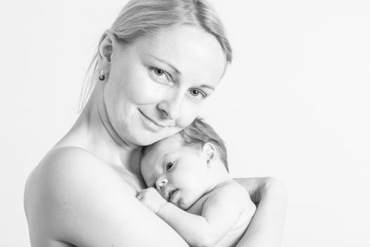 Black and white photo of a young mother holding her baby girl