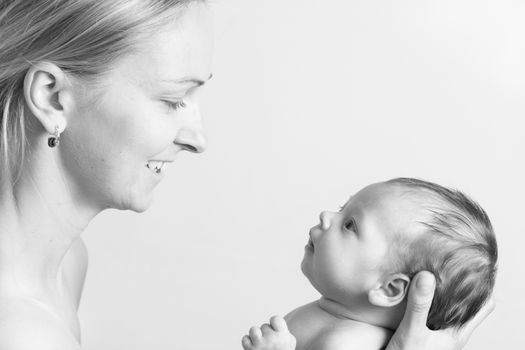 Black and white photo of a young mother holding her baby girl