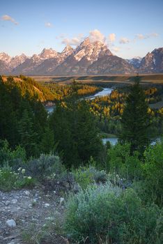 morning sunlight over Grand Tetons at a snake river overlook