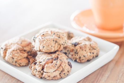 Closeup healthy cookies on white plate with coffee cup, stock photo