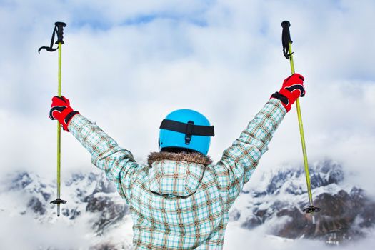 Ski, skier, winter - back view of lovely girl has a fun on ski