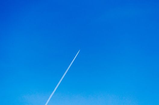 Aircraft leaving contrails in a cloudless sky.