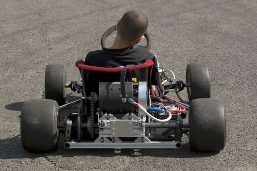 Santa Pod, UK - April 23, 2010: Alternative energy racing at Santa Pod Raceway. Battery powered go kart being prepared for a test run down a quarter mile drag strip.