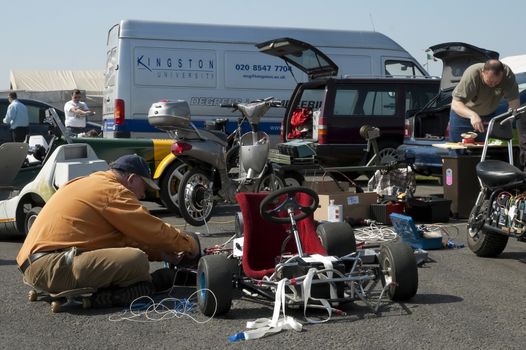 Santa Pod, UK - April 23, 2010: Alternative energy racing at Santa Pod Raceway. Engineers working on an assortment of electric vehicles before test runs down a quarter mile drag strip.