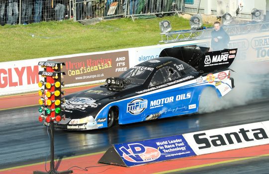 Santa Pod, UK - October 29, 2011: Burnout by the Shockwave funny car dragster at the Flame and Thunder event at Santa Pod Raceway in Northamptonshire, UK