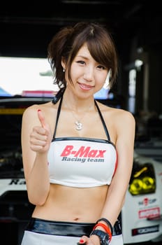 BURIRAM - OCTOBER 4: Unidentified Race Queen of Japan with racing car on display at The 2014 Autobacs Super GT Series Race 7 on October 4, 2014 at Chang International Racing Circuit, Buriram Thailand