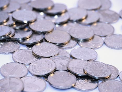 Bunch of Latvian lat coins on white background