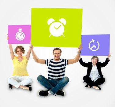 Casual people sitting and holding banner with clock sign