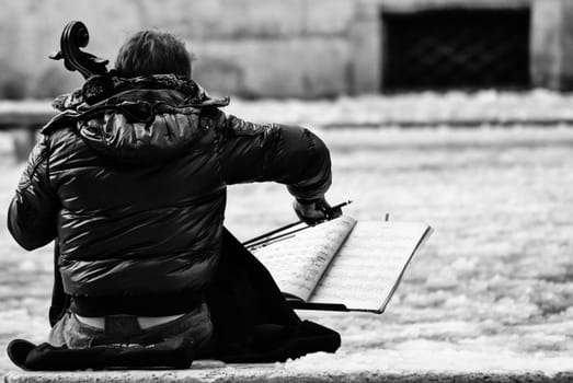 a musician plays his cello after an unusual snowfall in rome