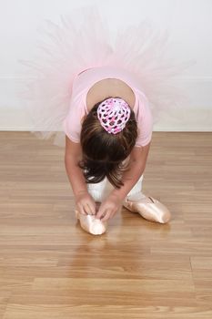 Little Brunette ballerina in the dance studio