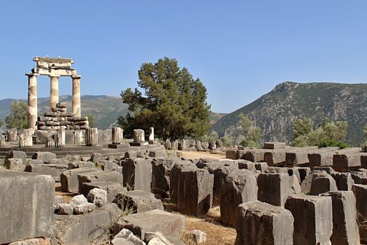 Photo shows old Delphi temple in the middle of the woods.