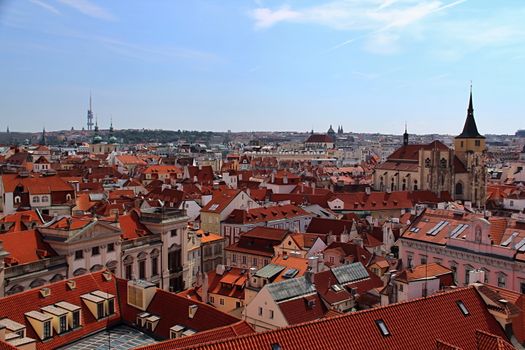 Photo shows details of Prague red roofs and old houses.