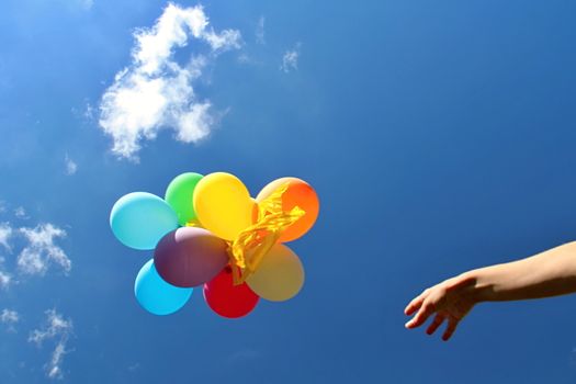 Photo shows colourful balloons in the sky.