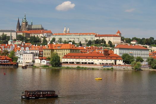 Photo shows details of Prague red roofs and old houses.