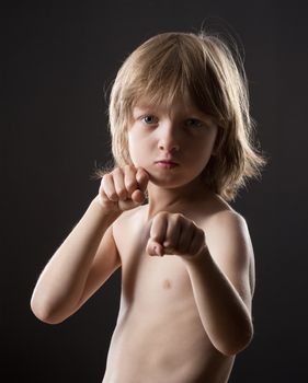 Boy with Blond Hair Striking a Fighting Pose