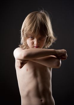 Boy with Blond Hair Striking a Fighting Pose