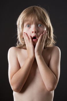 Boy with Blond Hair Surprised, Hands on his Cheeks