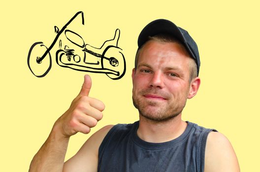 Young man with cap showing the thumbs up symbol in Hintergurnd a motorcycle chopper