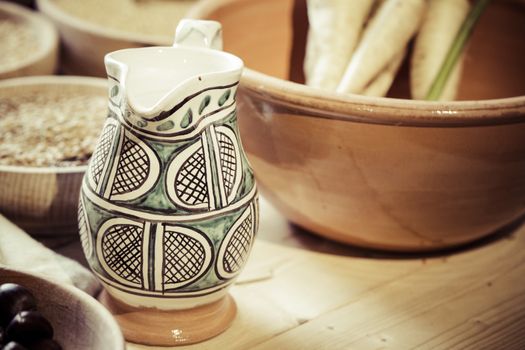 Picture of a table with a water jug and some traditional ingredients