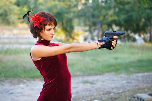 girl with gun on nature