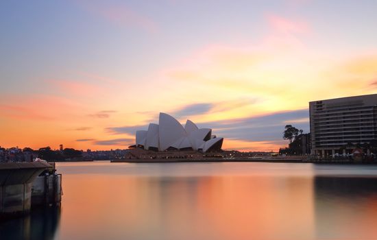 SYDNEY, AUSTRALIA - SEPTEMBER 17, 2014;  Sydney wakes up to colourful spring skies at sunrise.  Sydney Opera House and Sydney Harbourfrom Circular Quay Sydney.