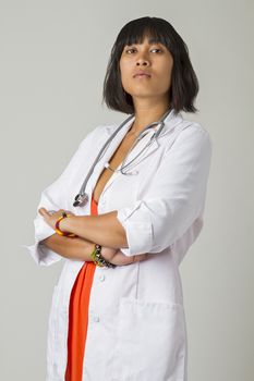 Young asian woman wearing a lab coat and a stethoscope