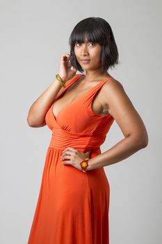 asian woman, wearing a low cut orange dress and a headset