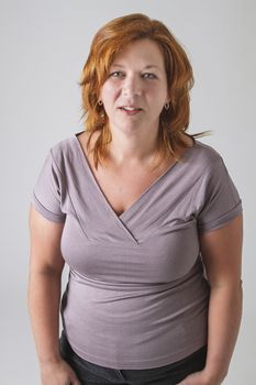round woman in her forties with red hair